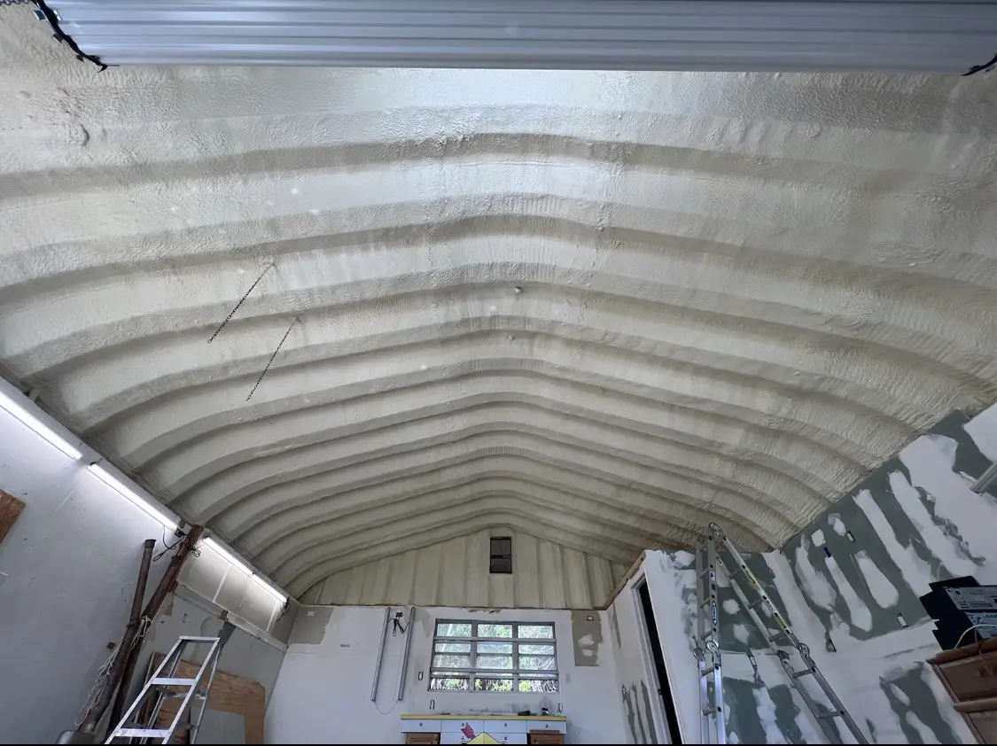 Spray polyurethane foam applied to the underside of a metal roof deck in Saline